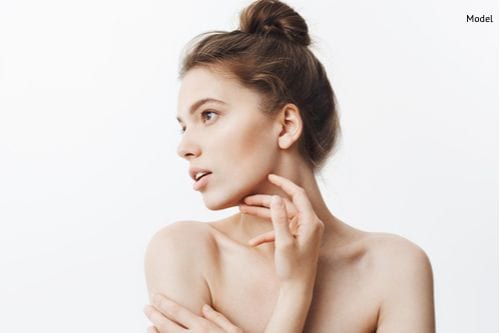 A woman seen enjoying her defined jawline, enhanced cheekbones, and strong facial structure after her facial implant surgery.